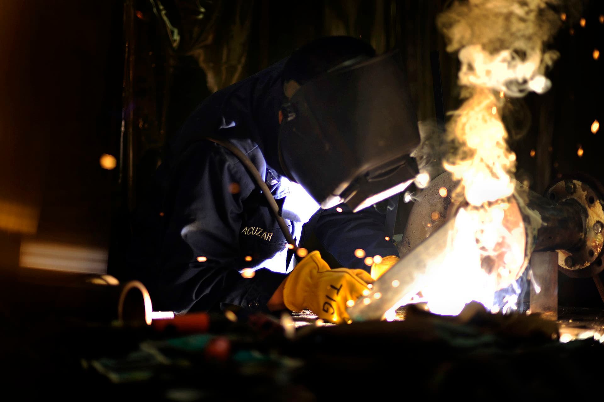 Welder performing TIG welding aboard ship