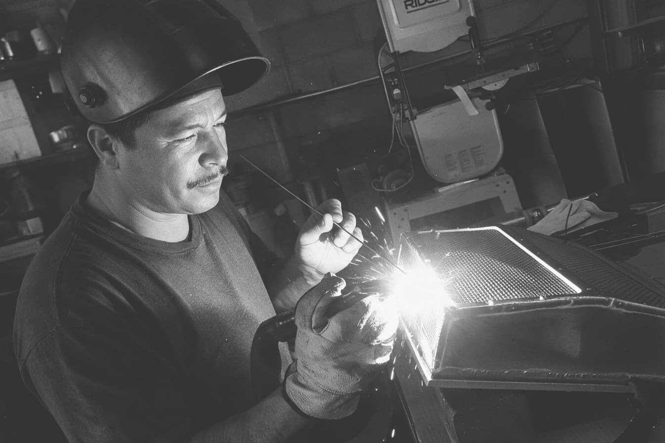 Samuel “Sam” Reyes Sr., founder of Nautilus Industrial Marine, TIG welding at a shop bench